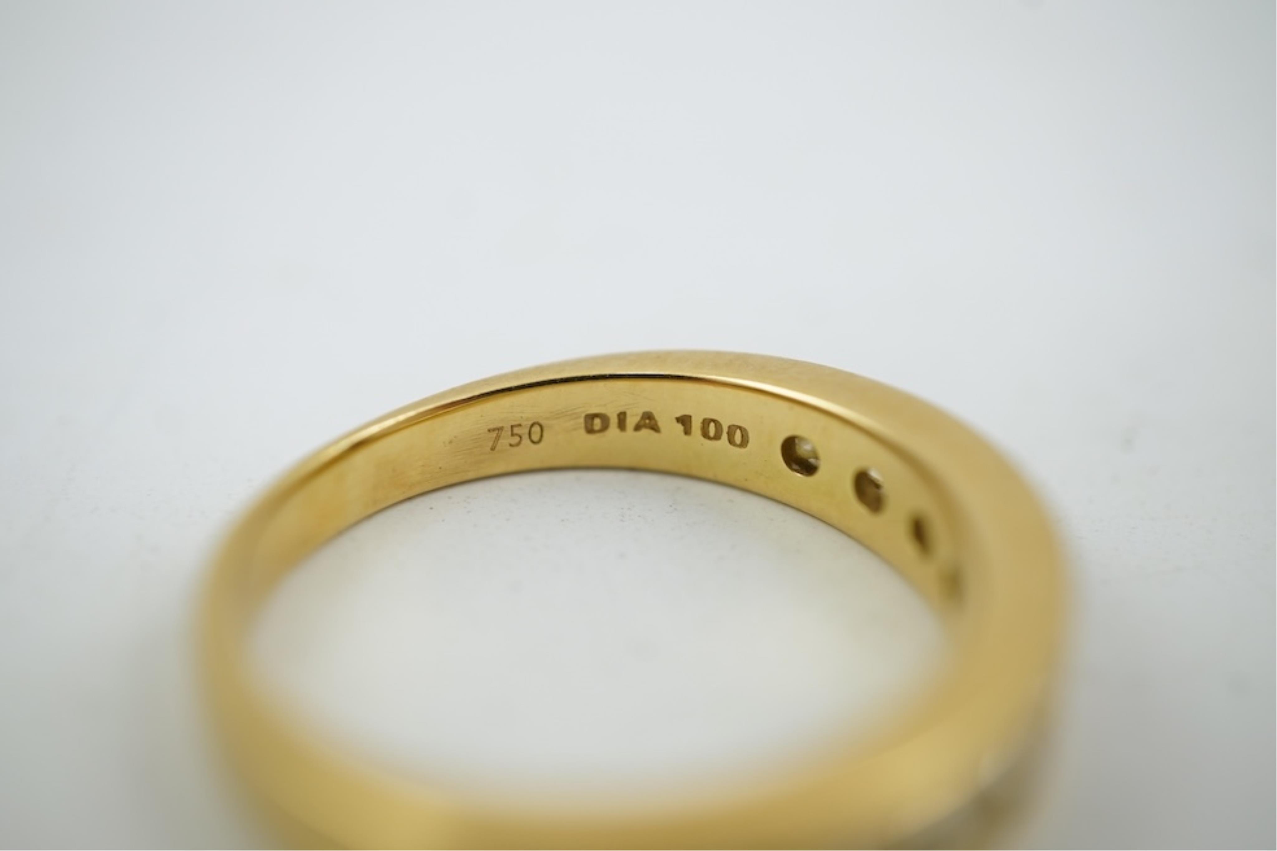 A modern 18ct gold and channel set graduated ten stone diamond set half eternity ring, size Q, gross weight 5.4 grams.